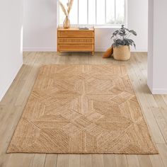 an area rug in the corner of a room with a wooden dresser and potted plant