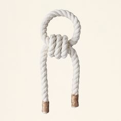 a white rope with two wooden ends hanging from it's end