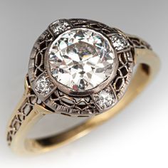 an antique diamond ring is shown in gold and silver with diamonds around the band,