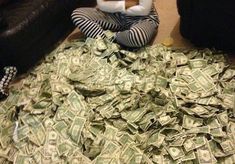 a stuffed animal sitting on top of a pile of money