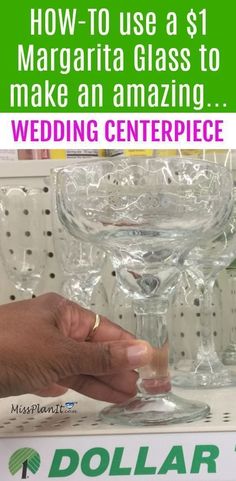 a person holding a glass in front of a display case with the words how to use $ 1 margarita glass to make an amazing wedding centerpiece