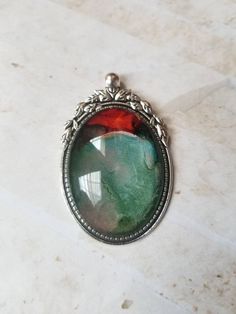 a green and red pendant sitting on top of a table