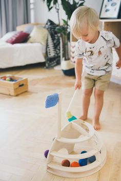 a toddler playing with a toy boat on the floor