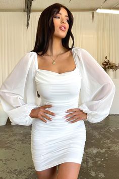 A bodycon babe! She features an all over ruched fabrication, off the shoulder, sheer long sleeves and is completed with an invisible back zipper. She looks amazing when paired with your go to Black heels and gold jewellery. FABRICATION: 100% polyester SIZING: Crystal wears a size AU 6 / US 2. How To Style A White Dress Classy, White Dress Classy Formal With Sleeves, Dresses For Modeling Fashion, Highschool Graduation Dresses White, Off Shoulder Dress White, Birthday Dresses For 16th Birthday, Long Bodycon Dress Outfit Birthday, White Long Sleeve Party Dress, Short White Dress Long Sleeve