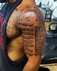 a man with a cross tattoo on his arm