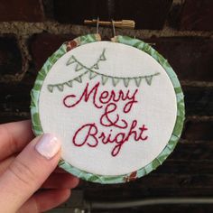 someone holding up a christmas ornament that says merry and bright