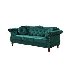 a green velvet couch with studded arms and buttons on the arm, against a white background