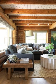 a living room filled with furniture and wooden walls