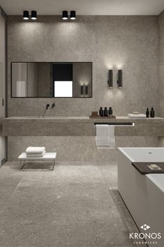 a modern bathroom with two sinks, mirrors and towels on the counter top in grey tones