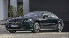 a black mercedes s - class parked in front of a building