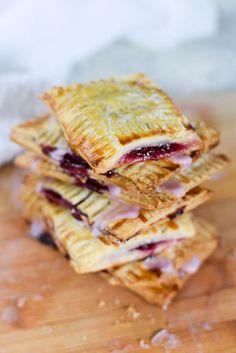 a stack of pastries sitting on top of a wooden cutting board