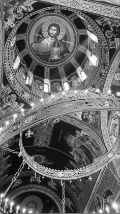 black and white photograph of the inside of a church with an ornate dome above it