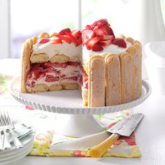 a cake with strawberries on top is cut in half