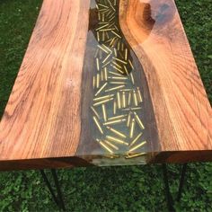 a table made out of wood and glass with some writing on it in the center