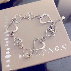 Silpada Spread Love Bracelet! Features 925 sterling silver linked hearts with a lobster clasp. Necklace is 7 1/2 inches in length. It can be found in the 2012-2013 catalog page 26C. Vintage item before silver went so high. Its solid silver! Display item in Excellent Condition! Super cute. Items will be sent in a gift bag with an anti tarnish strip. combined shipping is available SAVE ME AS YOUR FAVORITE SELLER! IM A FORMER REP AND HAVE HUNDREDS OF SILPADA ITEMS YET TO BE LISTED! MESSAGE ME IF YO Silver Heart Bracelet With Lobster Clasp For Anniversary, Sterling Silver Double Heart Bracelet, Silver Open Heart Bracelet For Valentine's Day, Silver Double Heart Bracelet For Anniversary, Elegant Silver Open Heart Bracelet, Valentine's Day Sterling Silver Bracelet, Nickel-free Silver Heart Bracelet For Anniversary, Silver Heart Bracelet With Sterling Clasp For Valentine's Day, Elegant Sterling Silver Heart Bracelet Nickel Free