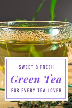 a glass cup filled with green tea on top of a wooden table