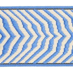 a blue and white chevroned pattern with black stitching on the bottom corner