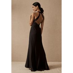 a woman in a long black dress looking back