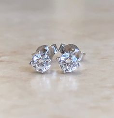 A classic and shiny pair of four prong diamond stud earrings crafted in 14 karat white gold with push backs for all gift occasions!! It features two round perfectly cut and calibrated natural diamonds weighing 0.10 carat each, D-F color VVS clarity.  These can be made in any diamond sizes, in 14 and 18 karat yellow or white gold, and platinum.  We also offer them separately for piercing use.  Birthstone: April. Condition: Excellent, New. - 14 day return policy, no questions asked. - Free insured Classic Platinum Cluster Earrings With Vvs Clarity, Classic Platinum Cluster Earrings In Diamond White, Classic Round Cluster Earrings In Platinum, Classic Platinum Diamond White Cluster Earrings, Round Platinum Cluster Earrings With Diamond Cut, Classic Round Platinum Cluster Earrings, Fine Jewelry Bridal Earrings With Vvs Clarity, Gia Certified Classic Diamond White Cluster Earrings, Classic Diamond Cluster Earrings For Anniversary