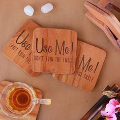 three wooden coasters that say use me, don't run the table and drink tea