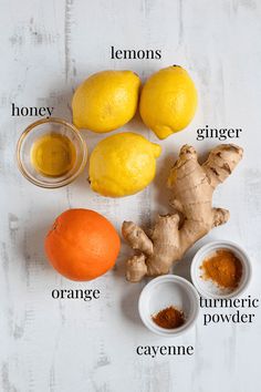 lemons, ginger, turment powder, and other ingredients on a white surface