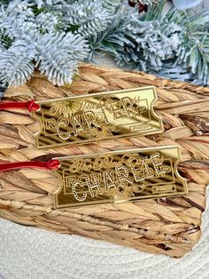 two gold christmas ornaments sitting on top of a white plate