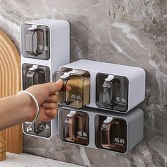 a person's hand is pressing the button on an automatic spice dispenser