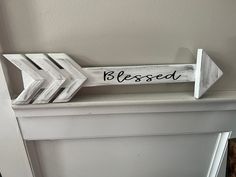 a wooden sign that says,'be loved'and an arrow with the word