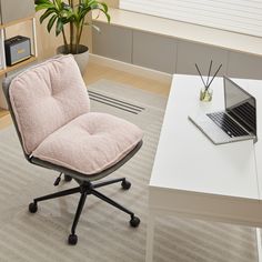 an office chair sitting in front of a desk with a laptop computer on top of it