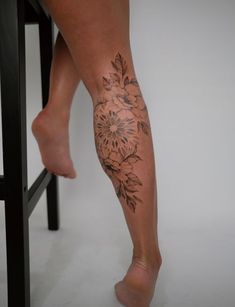 a woman's leg with flowers on it