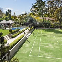 a tennis court surrounded by trees and bushes