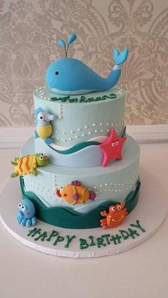 a three tiered birthday cake with an ocean theme