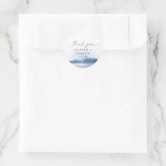 a white envelope with a round sticker on it