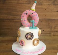 a birthday cake with donuts and doughnuts on top