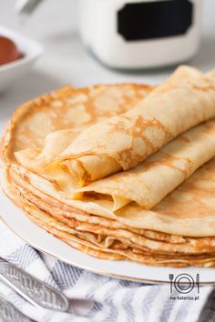 stack of pancakes sitting on top of a white plate