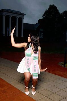 a woman in a white dress pointing at something