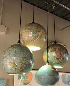 three globes are hanging from the ceiling