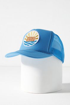 a blue trucker hat with the sun on it