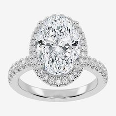 an oval cut diamond ring with pave set shoulders