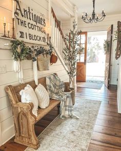 a wooden bench sitting on top of a hard wood floor next to a white wall