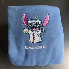 a blue bag with an elephant wearing a lab coat