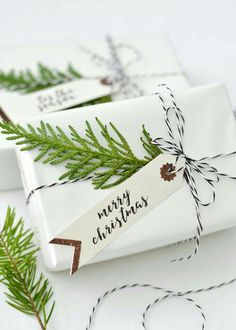 christmas presents wrapped in white paper and tied with twine