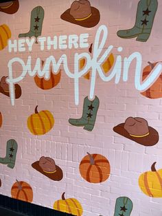 there is a mural painted on the side of a brick wall that says heythere pumpkin