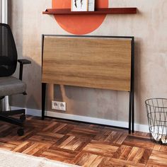 an office chair next to a desk with a book shelf above it and a clock on the wall