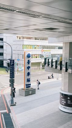 an empty parking lot with people walking around