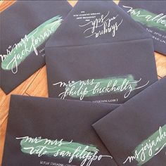 six black envelopes with white calligraphy on them