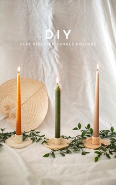 three candles sitting on top of a white table