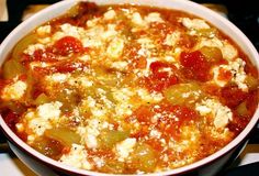 a white bowl filled with food on top of a stove