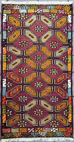 an old rug with colorful designs on it