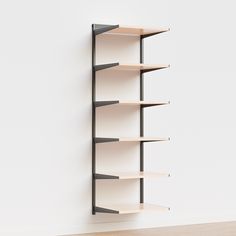 an empty book shelf against a white wall